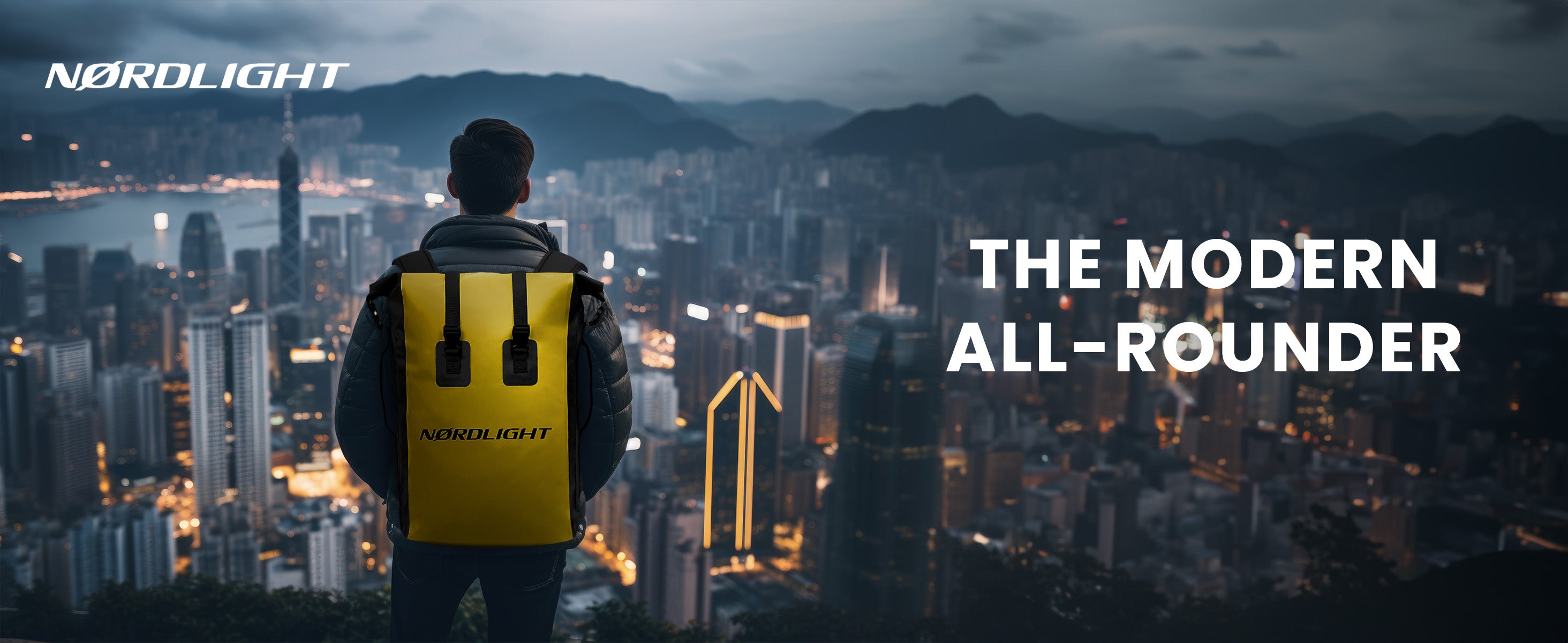Man wearing yellow Nordlight backpack stands on rooftop at dusk, overlooking cityscape as modern all-rounder.